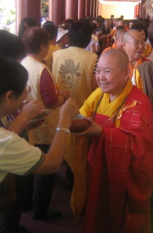 A high-ranking bhiksuni in the Chinese Buddhist tradition during an alms round. Venerabletzuchuang-cropped.JPG