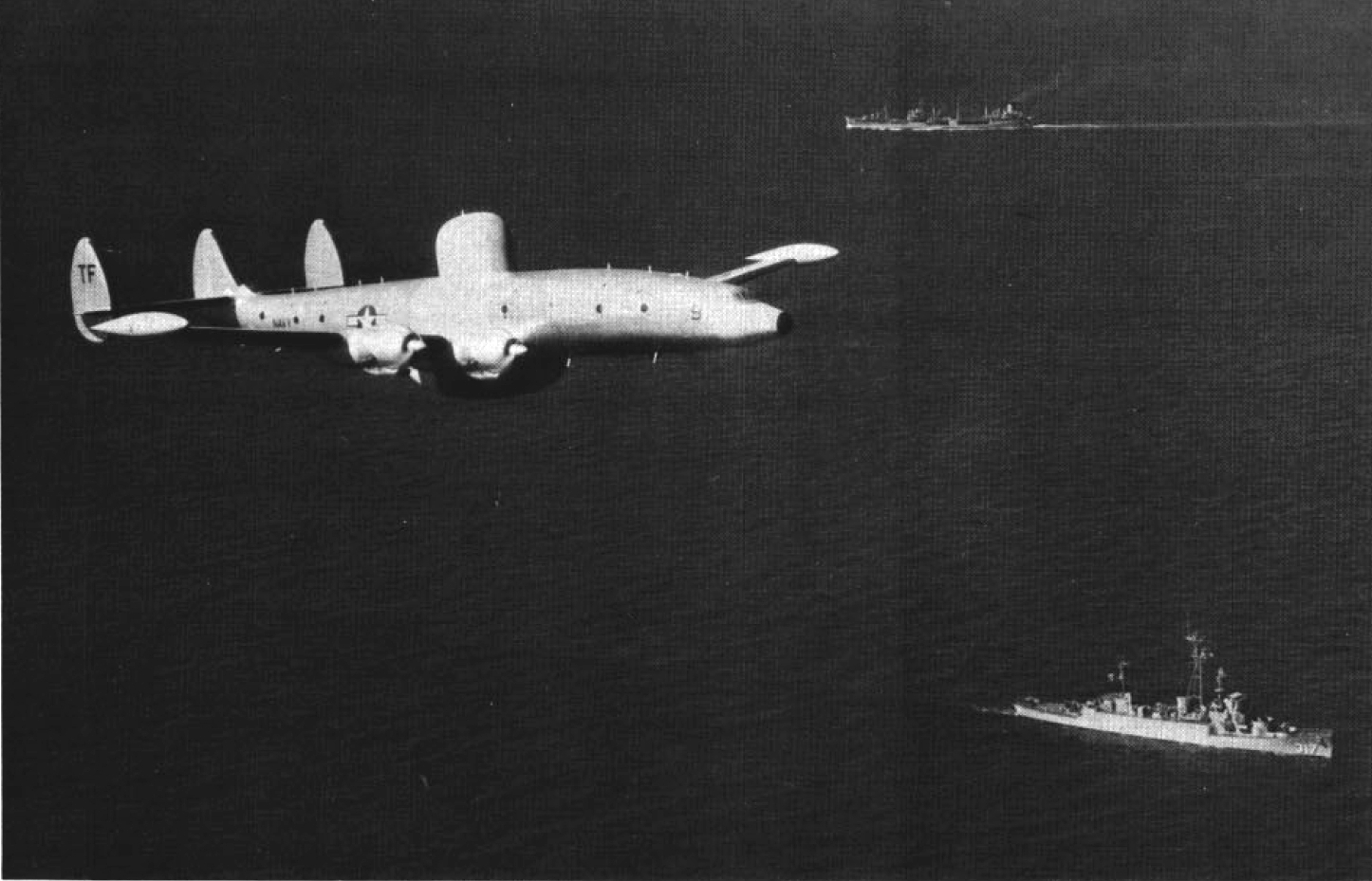 A U.S. Navy Lockheed VW-2 flies over the radar-picket destroyer escort USS&nbsp;<em>Joyce</em>&nbsp;(DER-317), in the 1950s.<em> (US Navy Photo)</em>