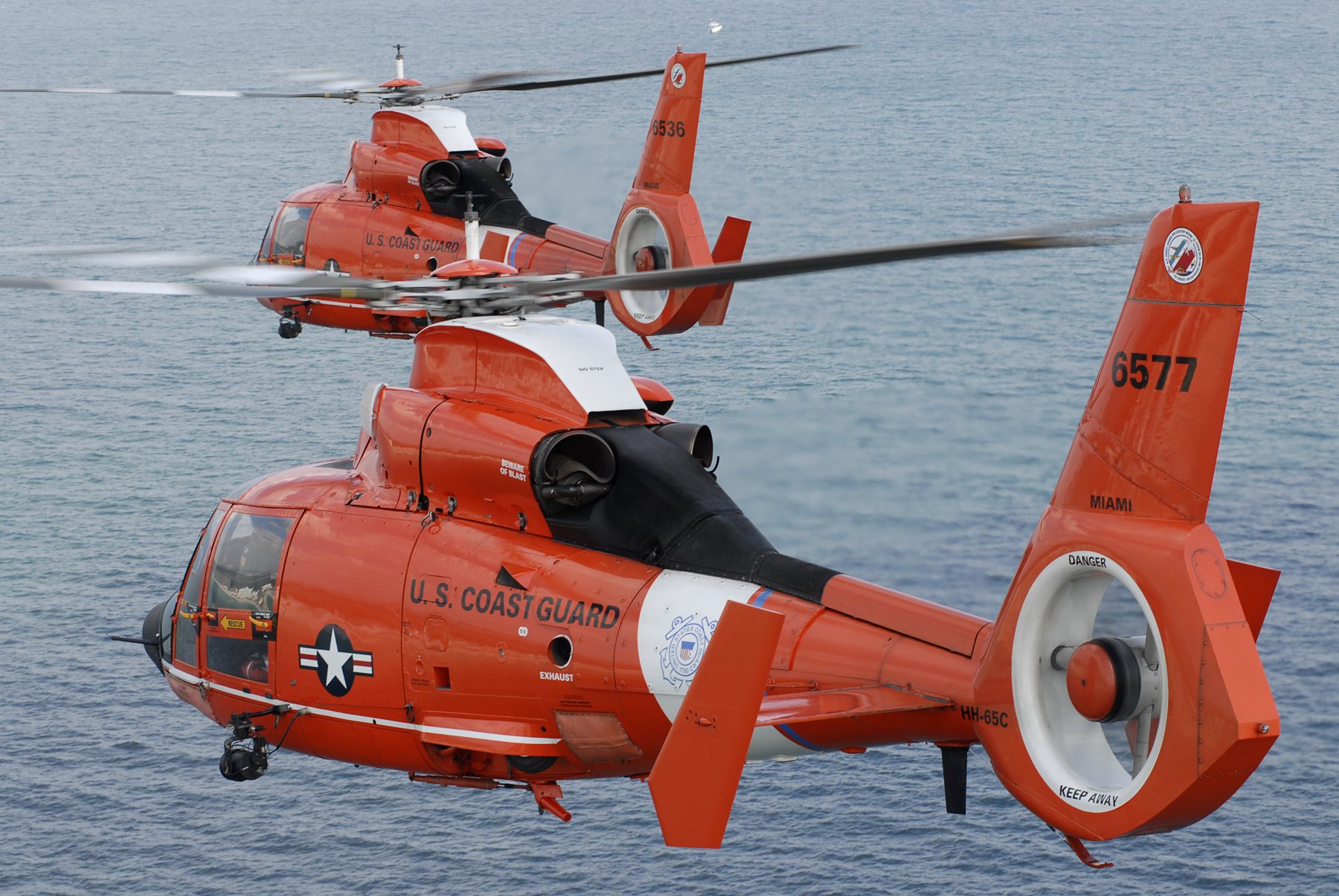 Two coast guard HH 65C Dolphin helicopters