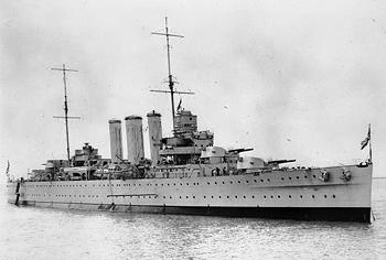 Rows of portholes can be seen on the hull of HMS Cornwall, a British heavy cruiser from the 1920s