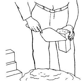 Figure 8 Proper way to hold a brick when buttering the end