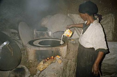 Batter is poured rapidly in a spiral from the outside inwards. Debre Markos, Ethiopia.