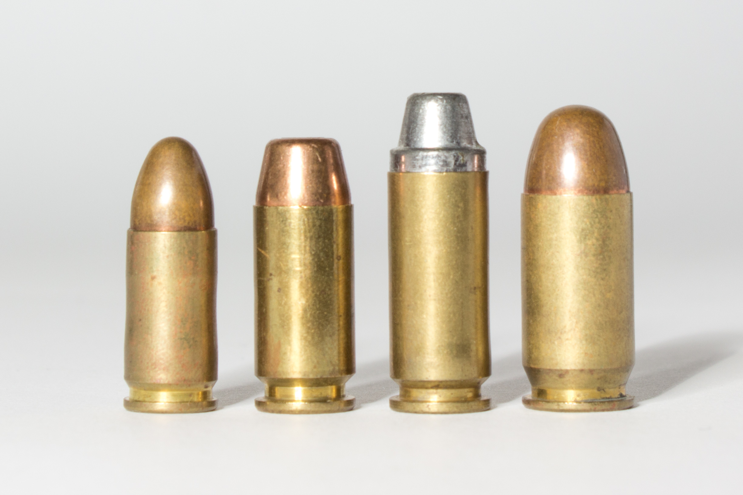 38, 9mm, and 22LR rounds with a large spent bullet casing - see