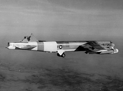 Black-and-white photo of a B-52 inflight with its vertical stabilizer sheared off.