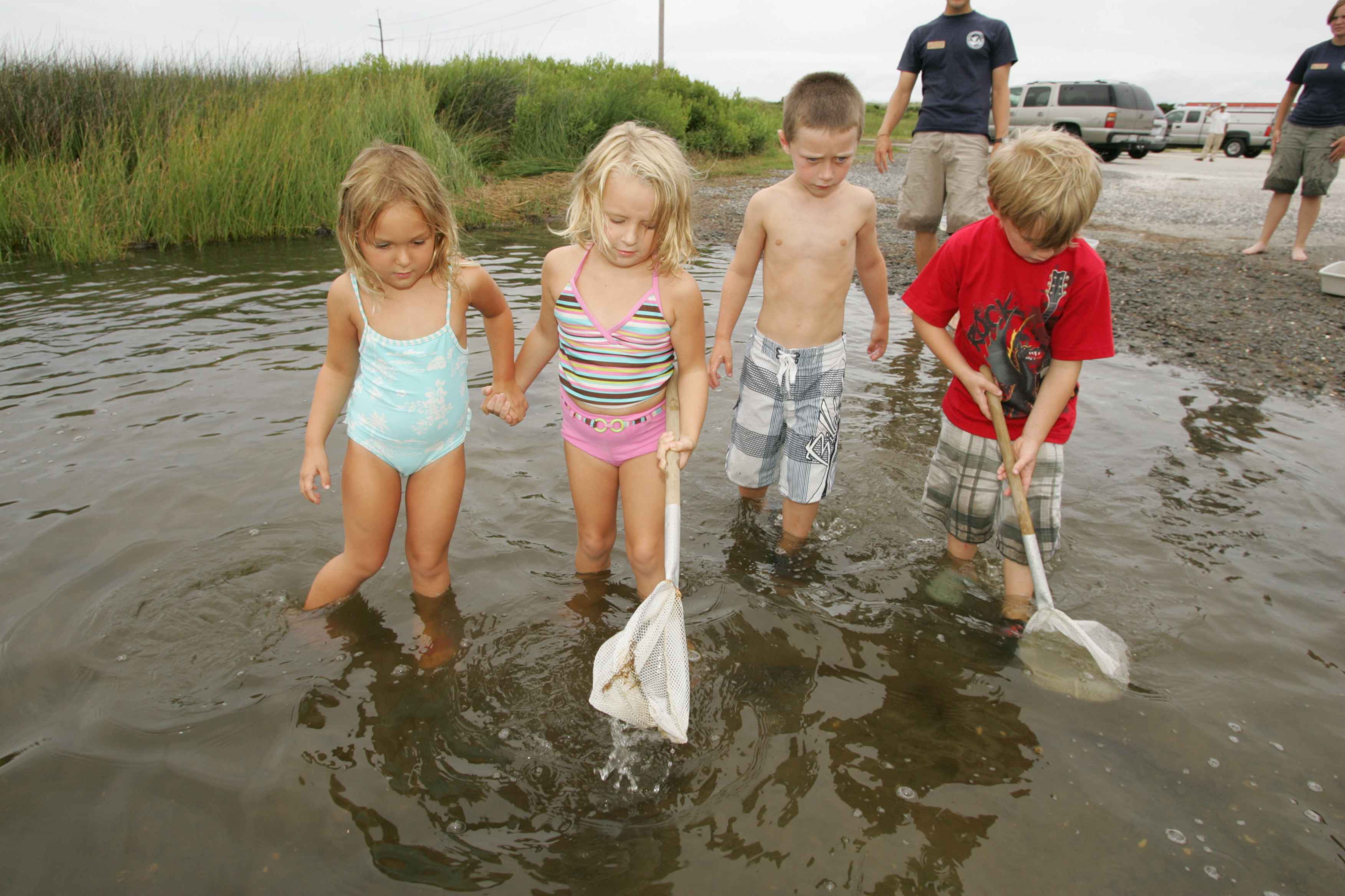 Two naked girls playing with one boy