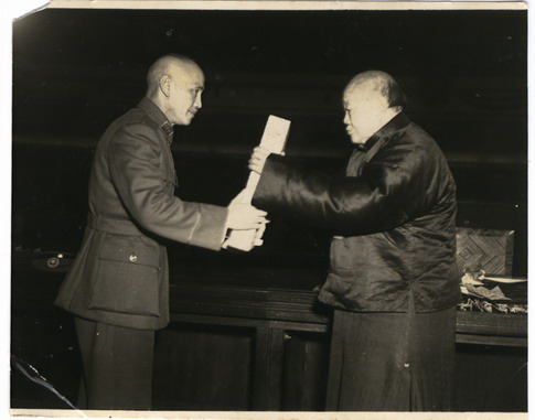 Wu Zhihui, chairman of the National Constituent Assembly, handed the ratified constitution to Chiang Kai-shek, chairman of the Nationalist Government.