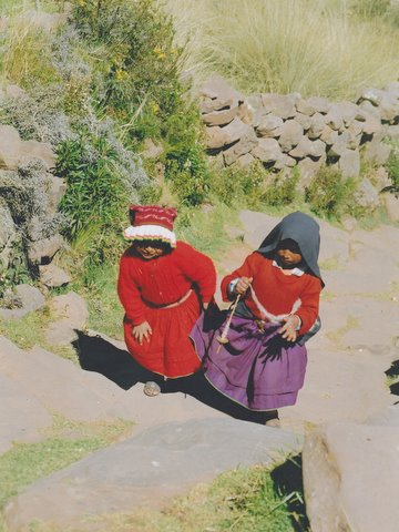 File:Two little child with a drop spindle in Peru.jpg