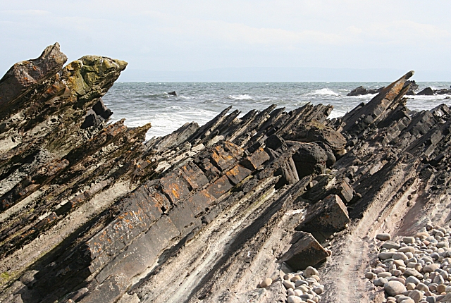 Sharp rock containing rock, sharp, and cliff