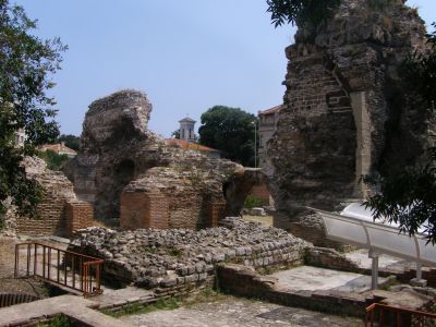 Roman Thermae west apodyterium with St. Athanasius church bell tower in the background