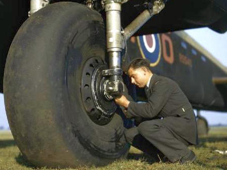 File:Testing the tyre pressure of Avro Lancaster R5540 of No 44 Squadron Conversion Flight at Waddington, Lincolnshire (cropped).jpg