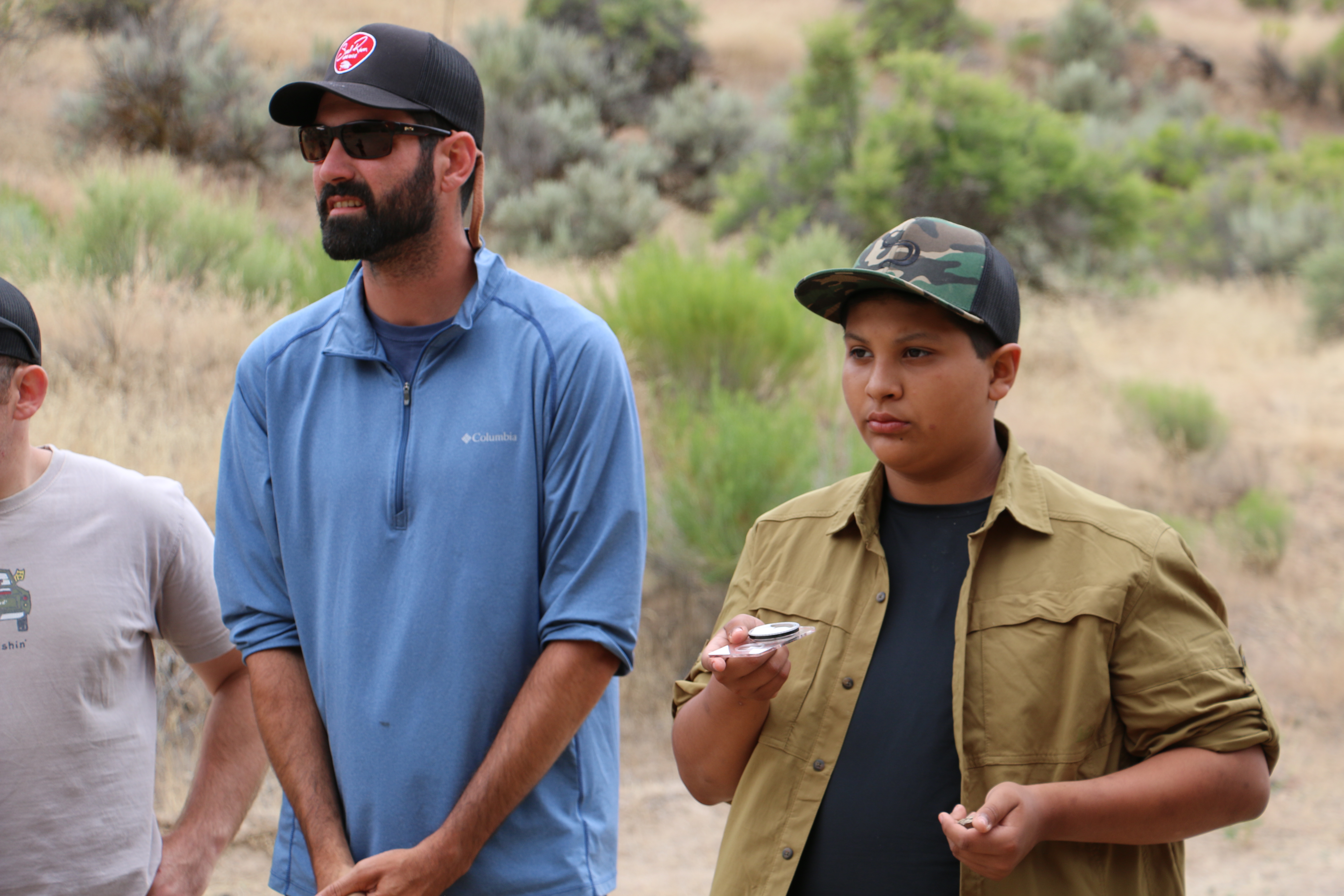 File:A veteran teaches a youth how to navigate with a compass at a