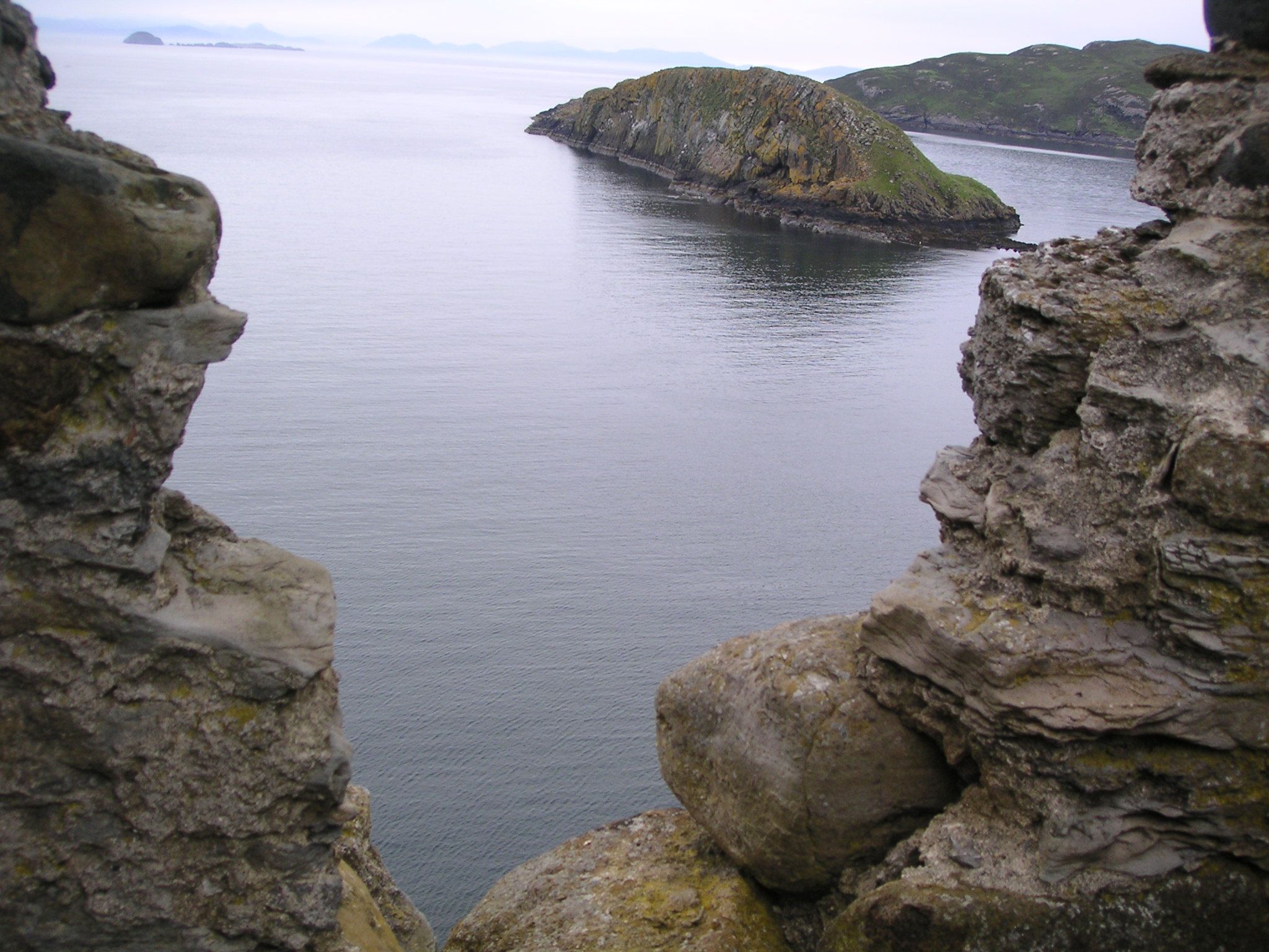 A rocky island in the middle of a body of water