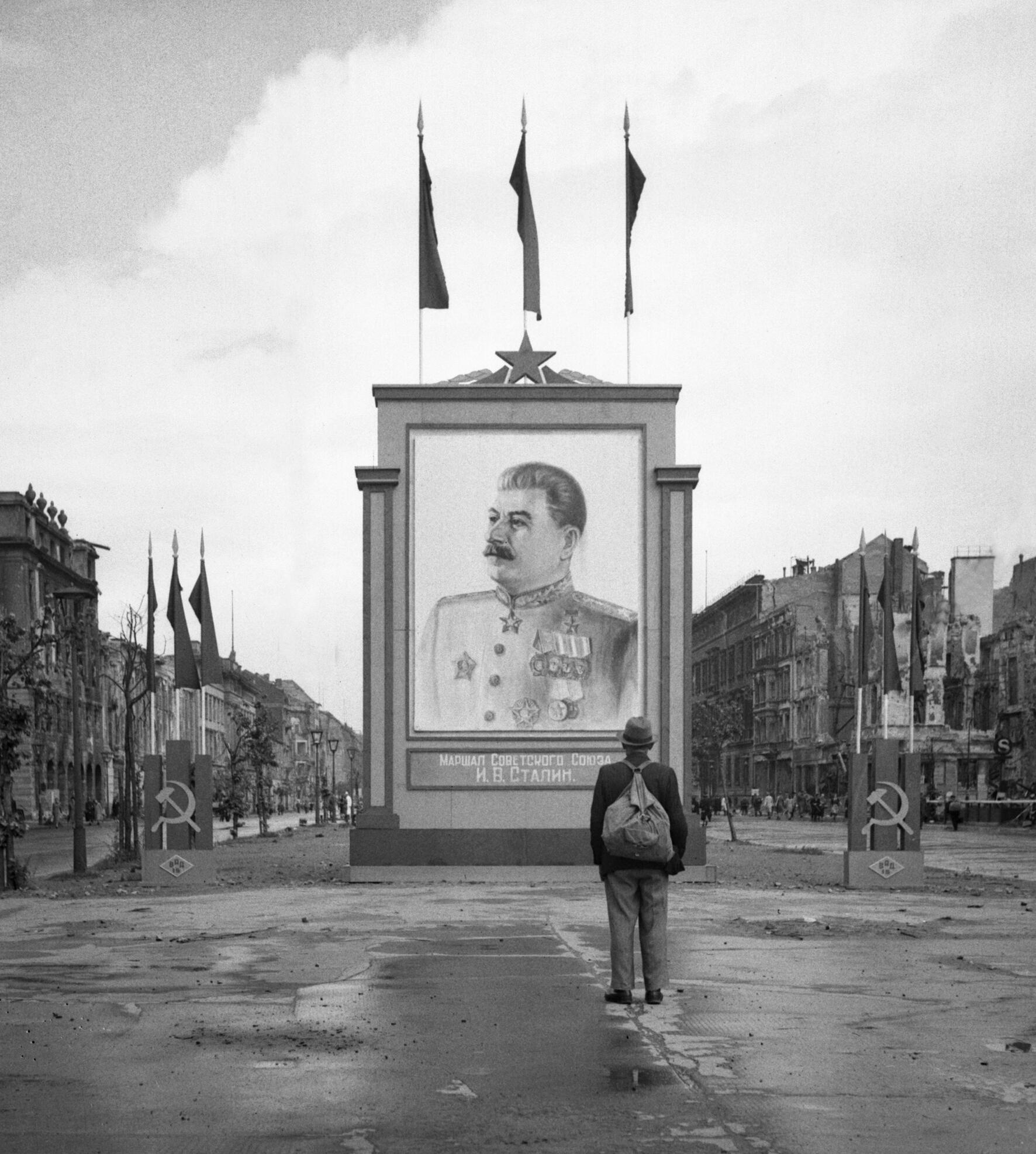 Marseille A_German_civilian_looks_at_a_large_poster_portrait_of_Stalin_on_the_Unter-den-Linden_in_Berlin%2C_3_June_1945._BU8572