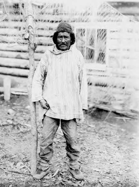 File:Native man wearing cloth parka and fur hat standing beneath fish  netting outside a log cabin, Yukon, 1905 (AL+CA 6138).jpg - Wikimedia  Commons