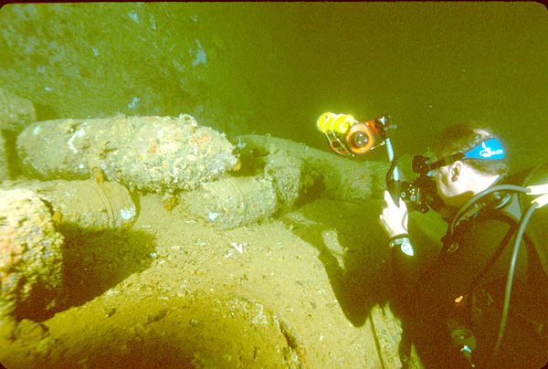 File:Diver photographing artillery shells in hold of the Yamagiri Maru wreck, Truk Lagoon, Micronesia.jpg