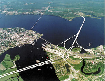 Aerial view of New Bern (center left) showing the confluence of the Trent (bottom center) and Neuse (left to right) rivers.  East is up.  The two larger bridges carry U.S. 70, U.S. 17, and NC 55, bypassing New Bern to the south through the unincorporated community of James City.  The smaller bridge crossing the mouth of the Trent River is Front Street, while the smaller bridge crossing the Neuse is a railroad bridge.