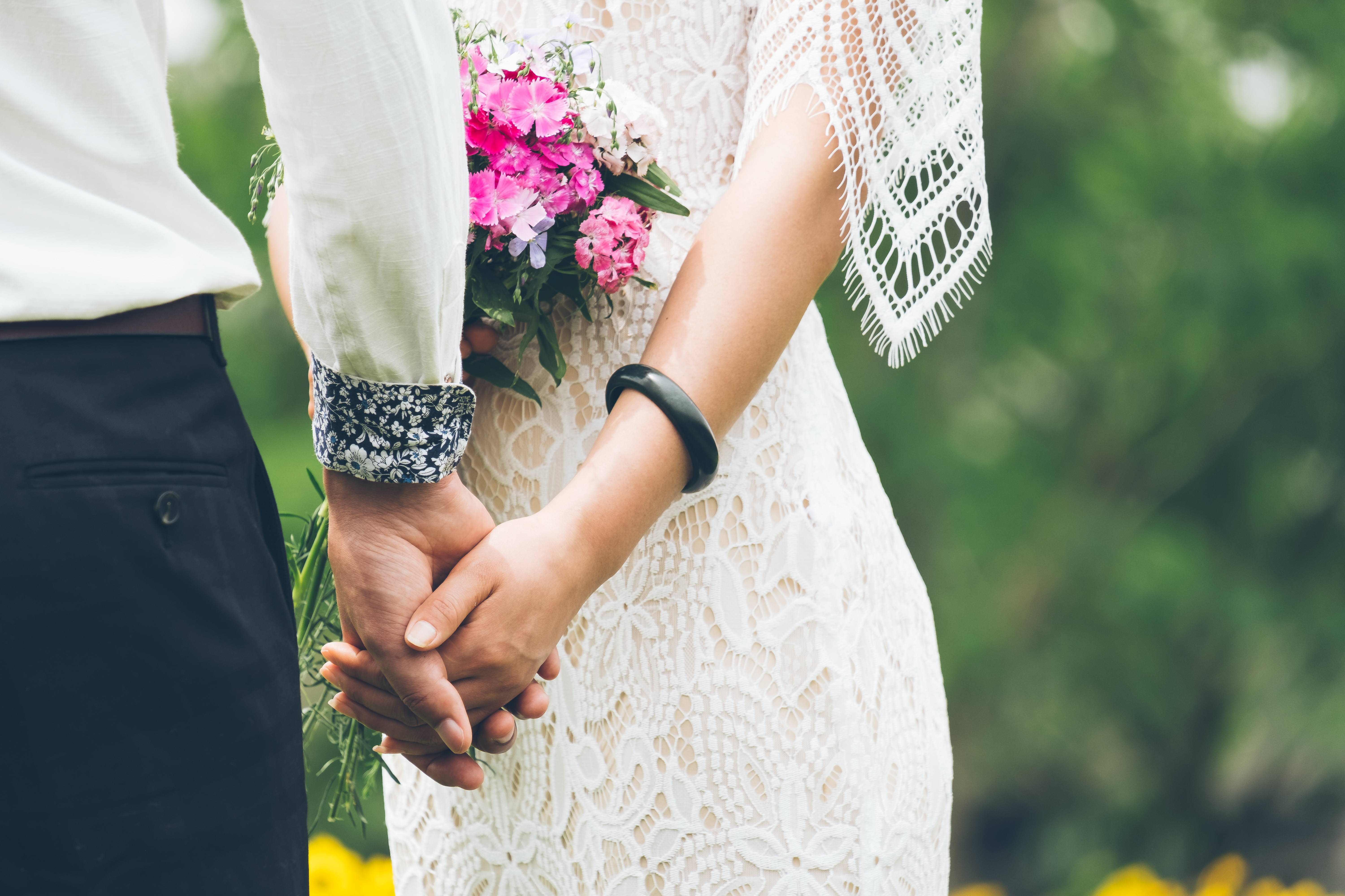 real bride and groom holding hands