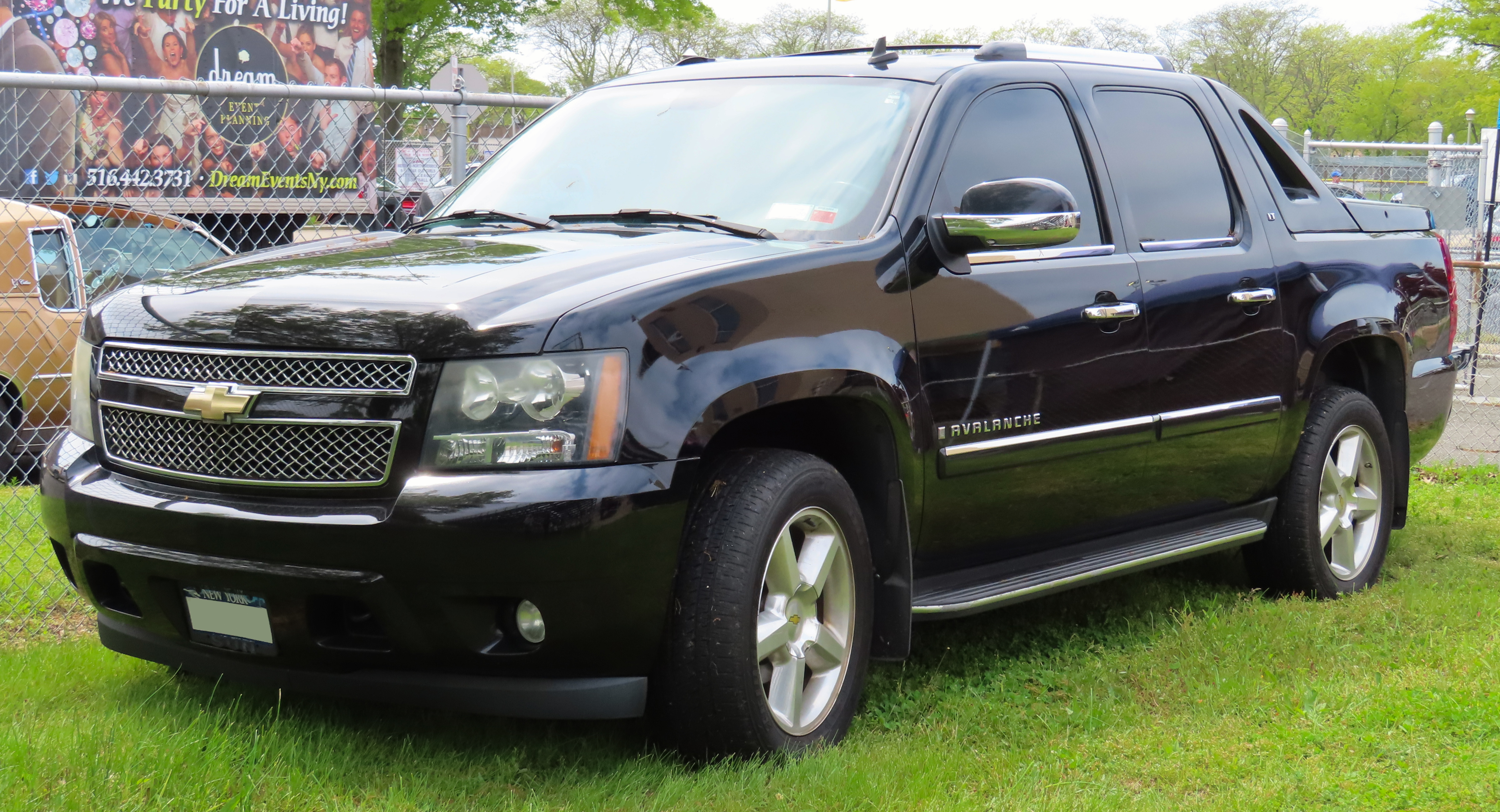 Black Chevy Avalanche parked on grass