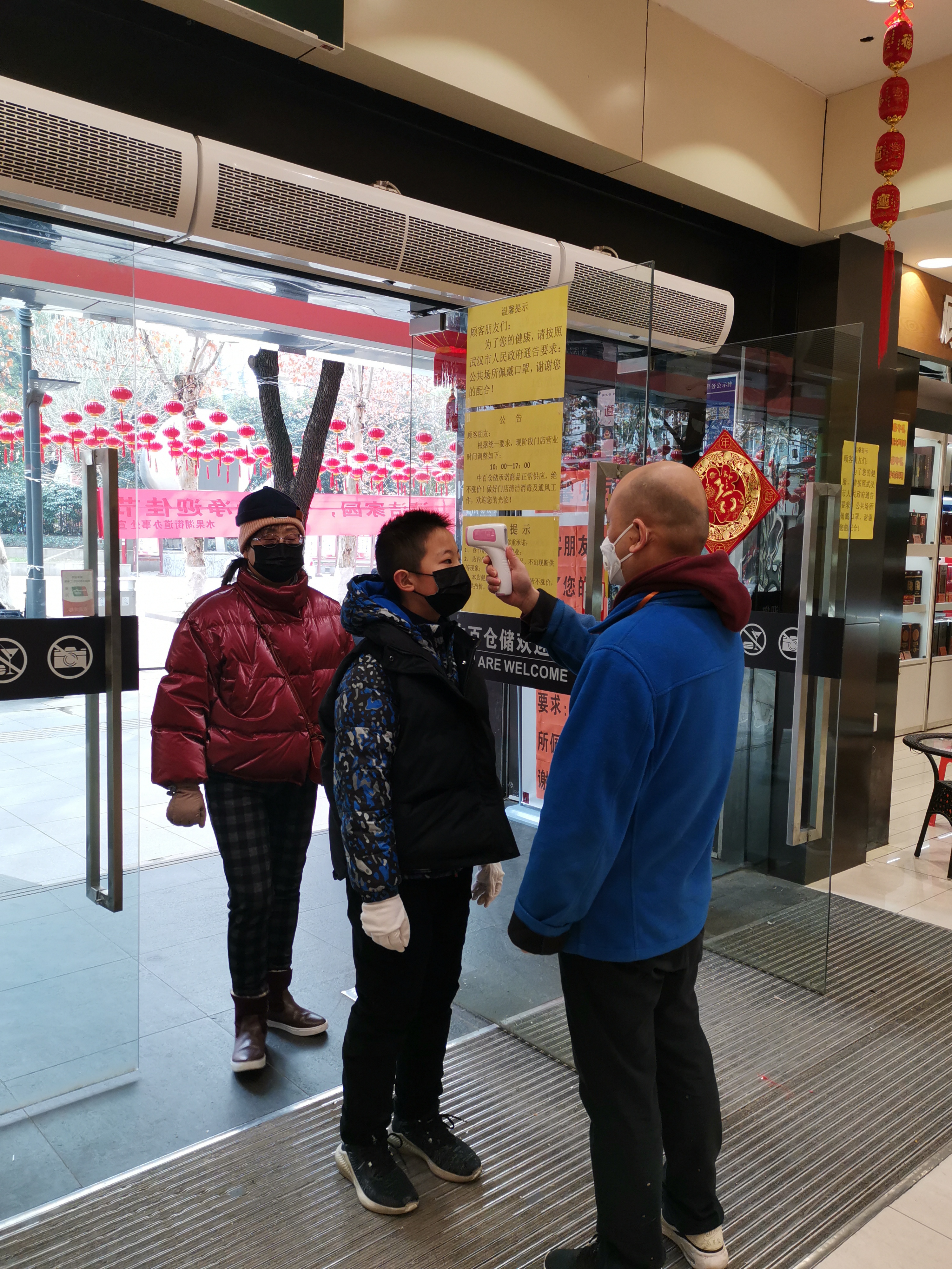 Customers who were measuring body temperature before entering the supermarket in Wuhan during 2019-nCoV coronavirus outbreak