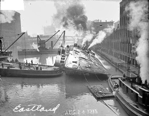 The steamer Eastland being righted after capsizing in the Chicago River near the Loop community. Chicago Daily News, Inc., photographer. 