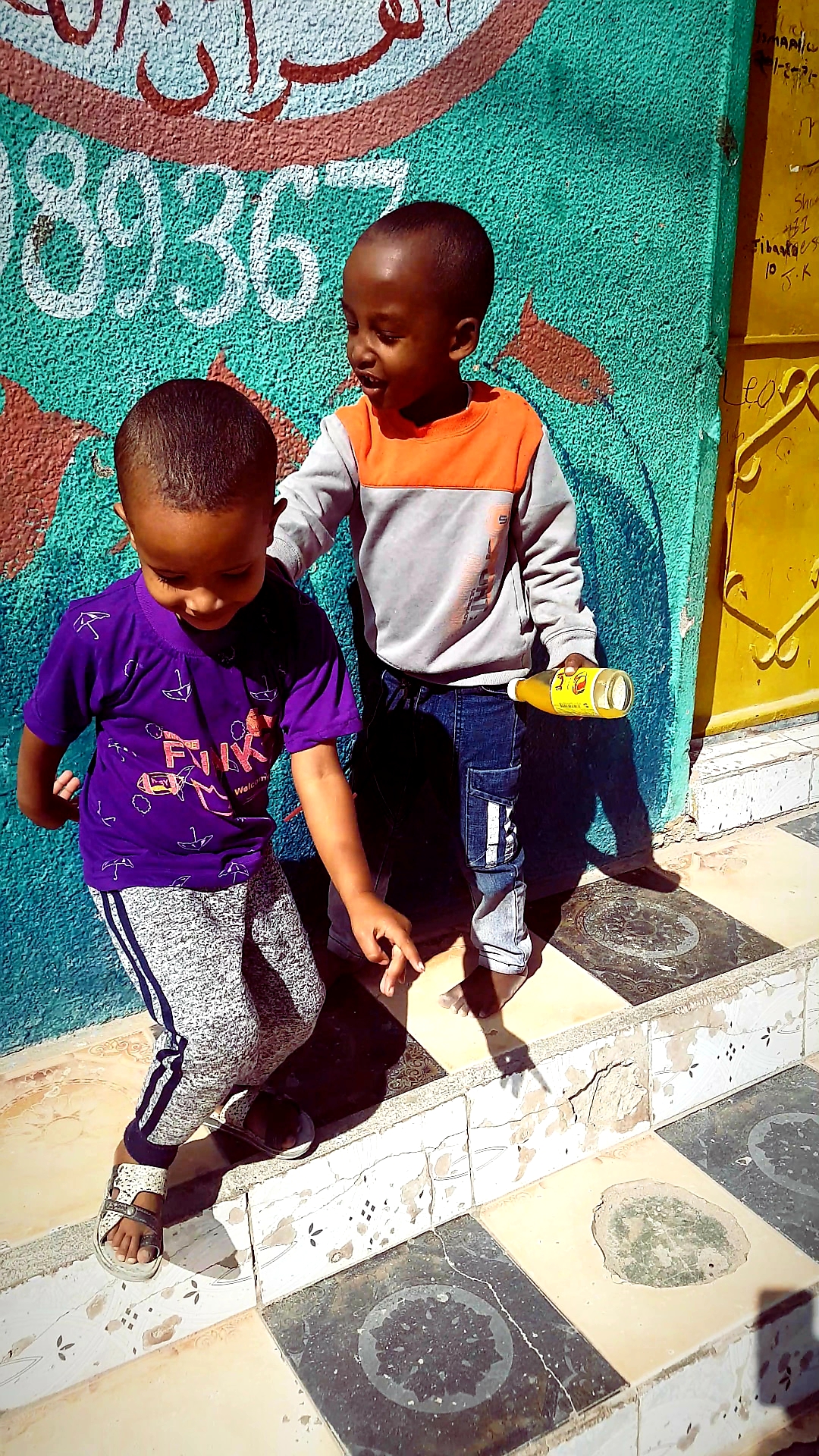 A cheerful picture of two young boys playing together