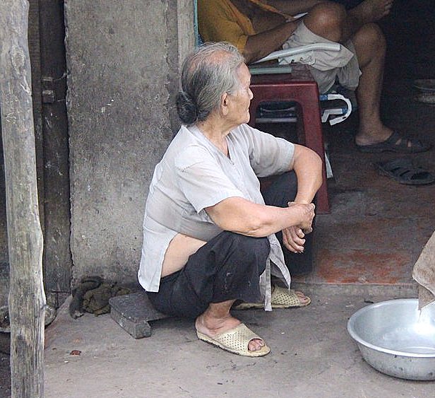 File:Old female sitting on small bench Vietnam.jpg