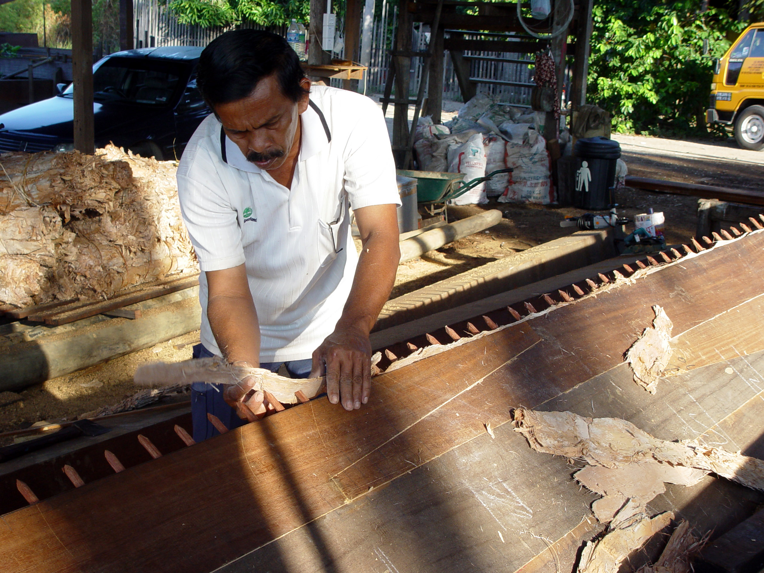 File:Traditional Malay boat building - applying the caulking bark