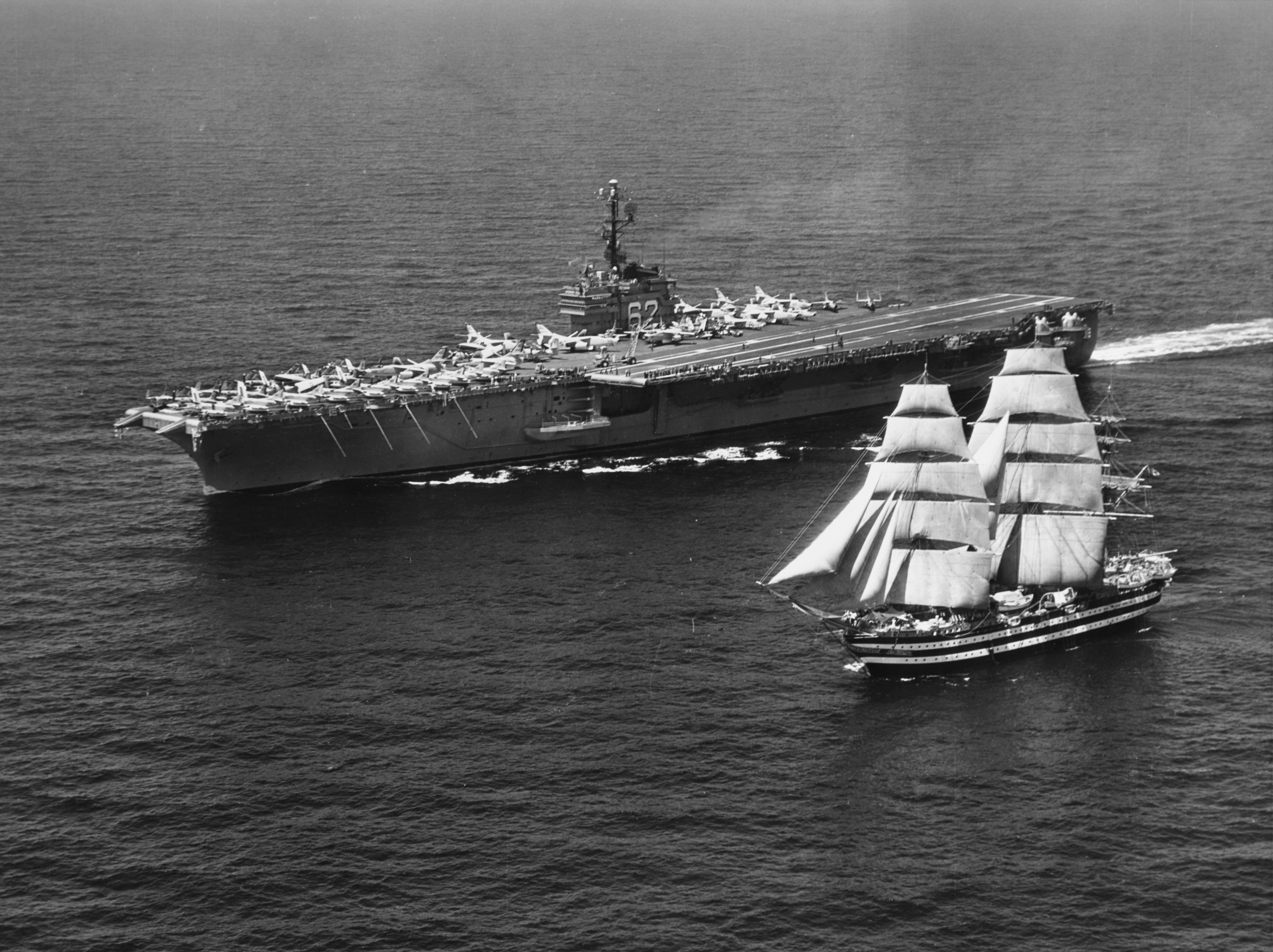 USS Independence (CVA-62) underway with sailing ship Amerigo Vespucci in the Mediterranean Sea, 12 July 1962 (USN 1061619).jpg