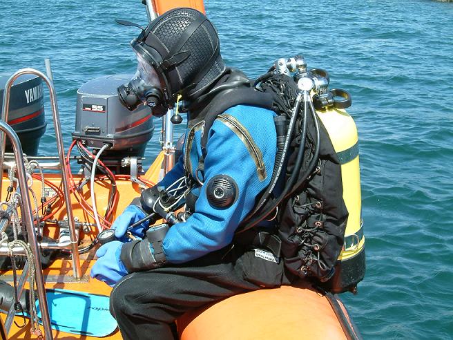 A SCUBA diver about to enter the sea from an RIB.