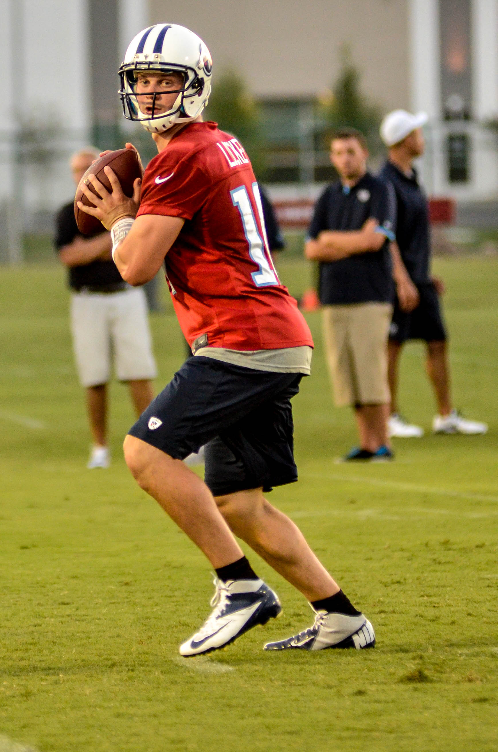 Tennessee Titans quarterback Jake Locker (10) scrambles against