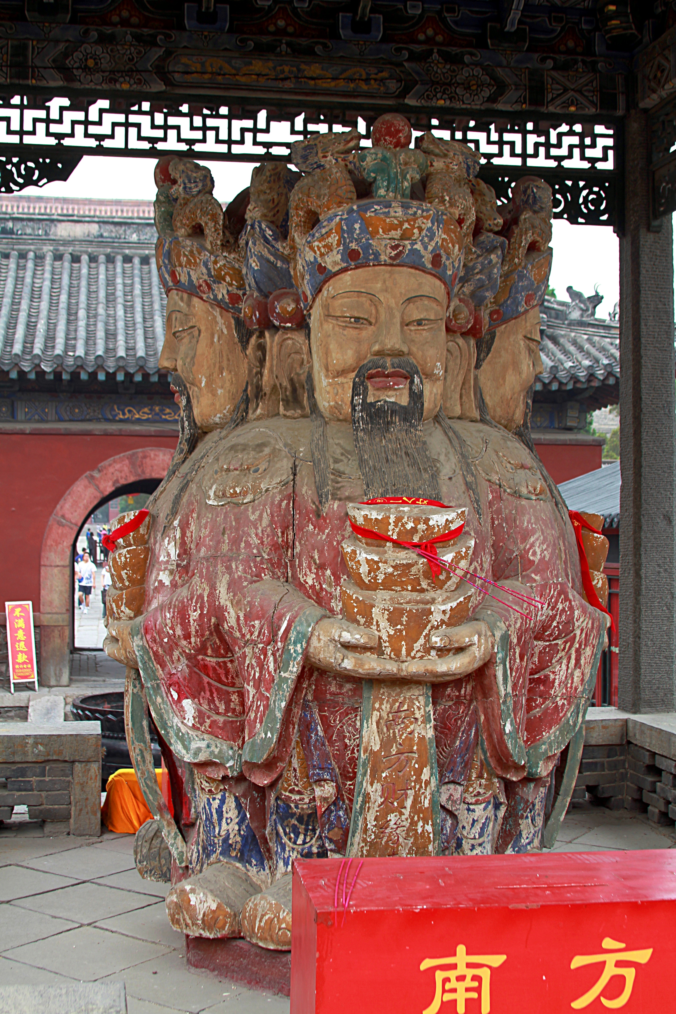 Photograph of a sculpture in the Taoist Dai Temple. Apparently showing at least 4 faces on one being