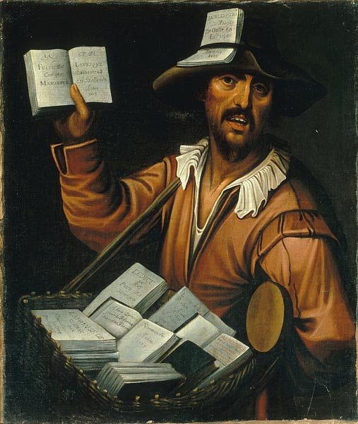 A man with a tray of small books hung around his neck holds one up for viewing. He also has one tucked in his hatband. His mouth is open as though calling out.