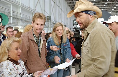 Keith visits with fans during brief breaks in filming the music video "American Soldier" in hangar 1600 at Edwards Air Force Base on November 17, 2003.