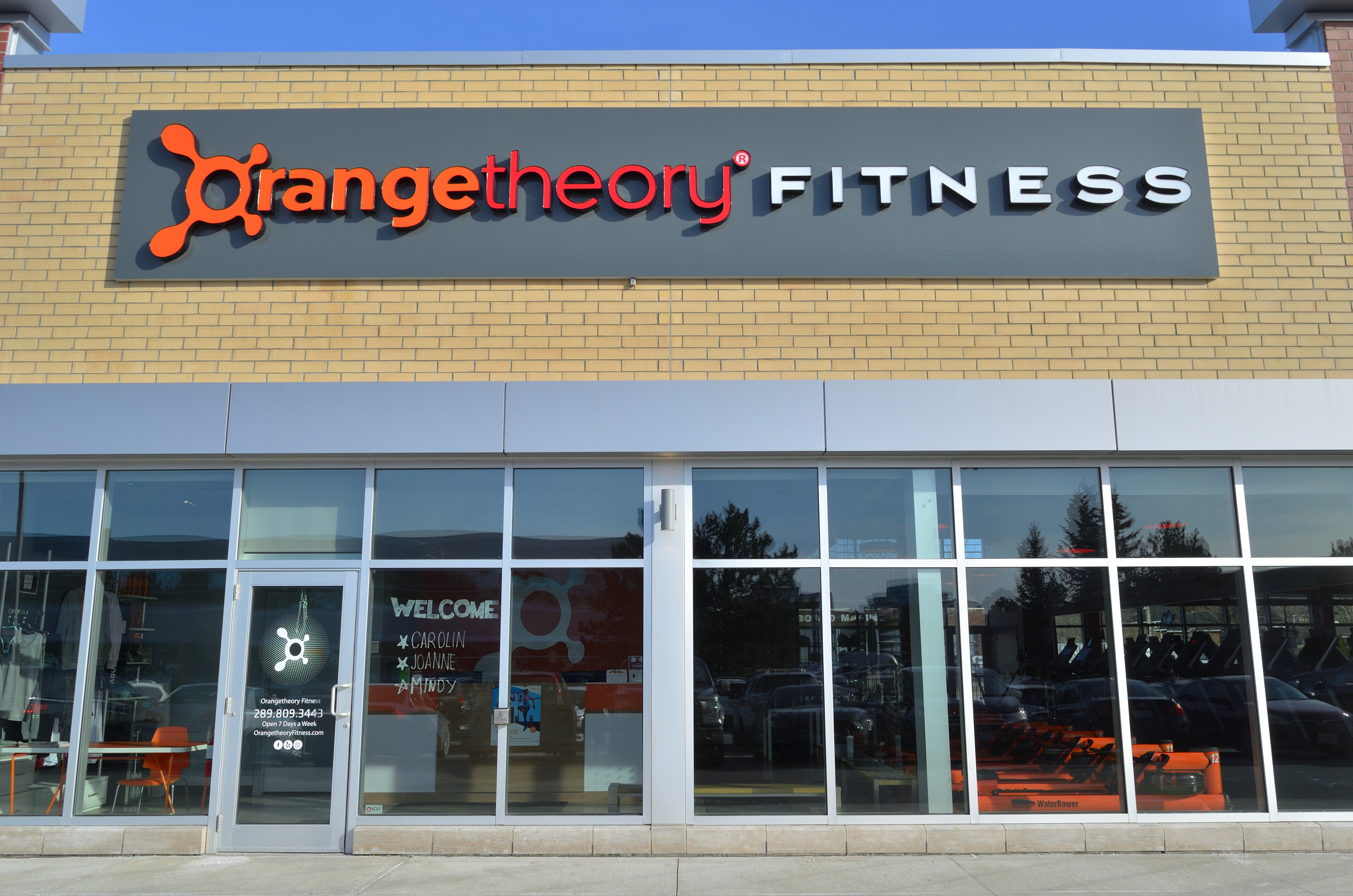 New York, USA - Circa 2018: Orange Theory Fitness exterior gym studio store  front franchise facade and sign. View from parking lot. Heart rate interva  Stock Photo - Alamy