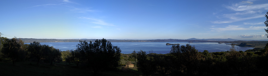 The eastern shore viewed from highway SS312 Castrense between Valentano and Latera on the western shore. Center is Bisentina, with Martana to the right and the headland of Capodimonte to the right of it. The city on the left of the far shore is Bolsena