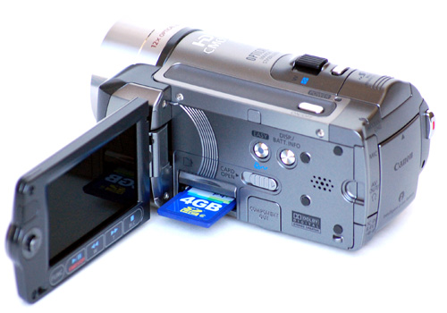Canon HF100 camcorder with a partially inserted Secure Digital card.
