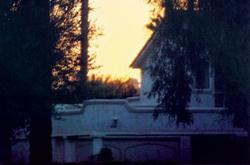 The house above appears a light cream during midday, but seems to be bluish white here in the dim light before full sunrise. Note the color temperature of the sunrise in the background.