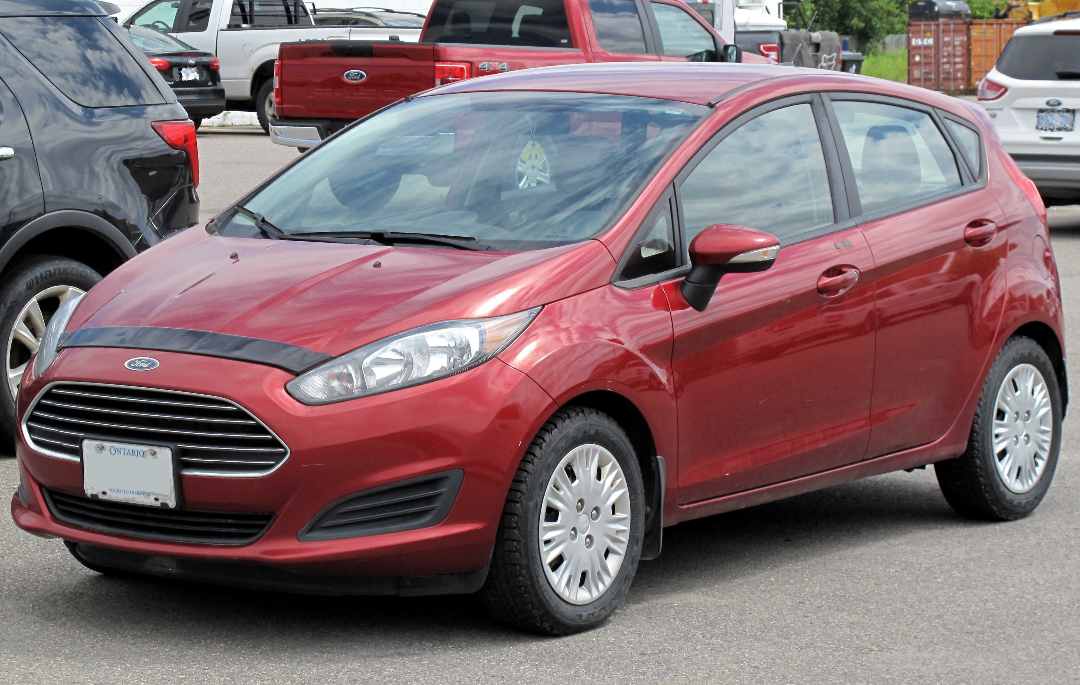 File:2014 Ford Fiesta SE in Ruby Red Metallic Tinted Clearcoat, Left, - Wikimedia Commons