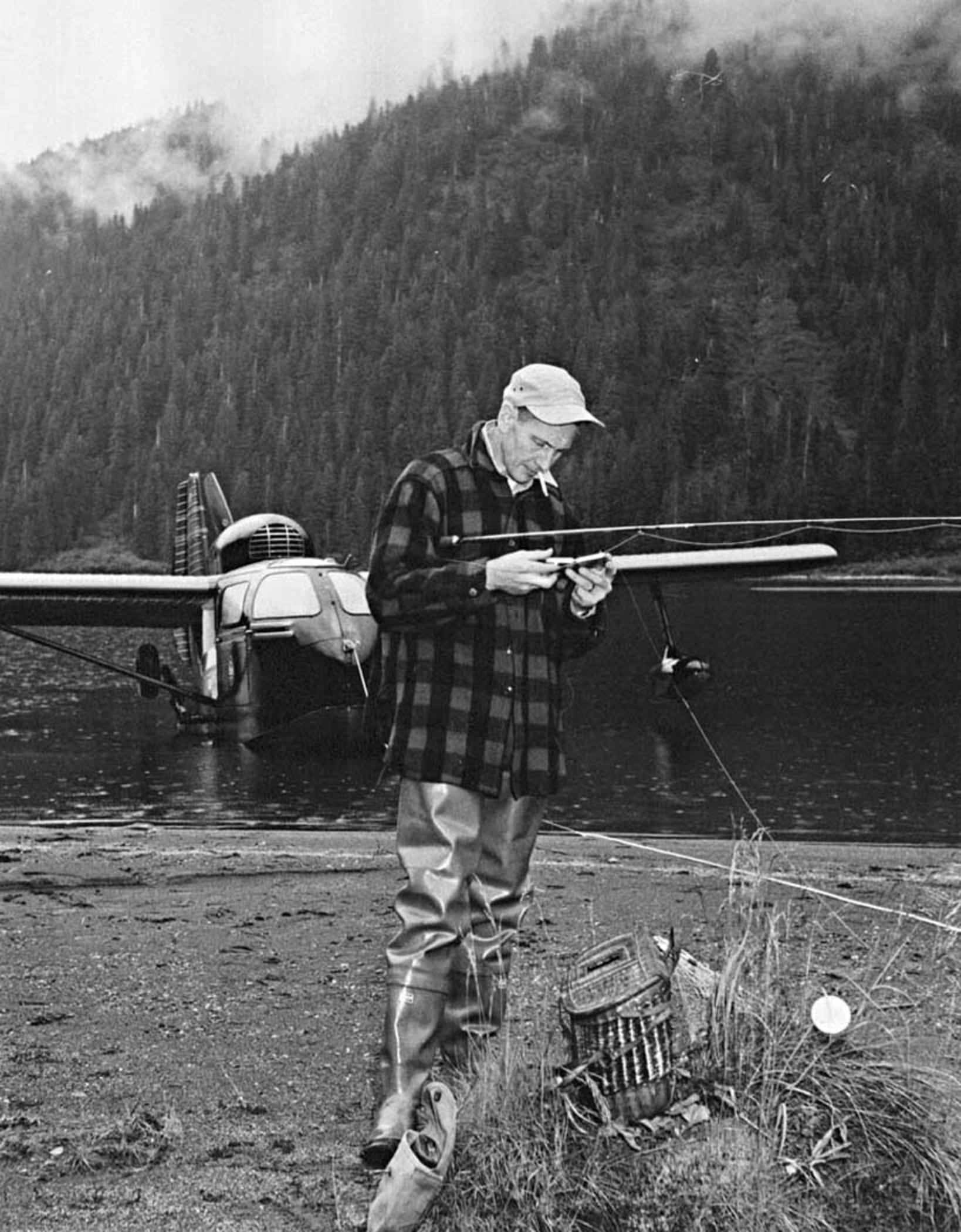 File:Fisherman assembling fly rod at lake vintage photo.jpg