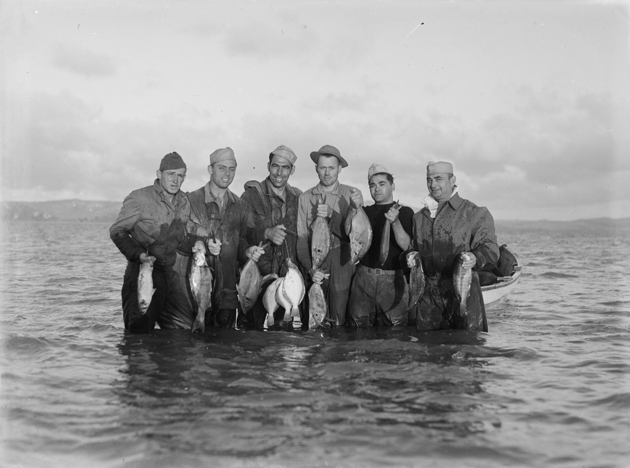 File:Group portrait of servicemen standing in the water and holding up  caught fish (AM 76388-1).jpg - Wikimedia Commons