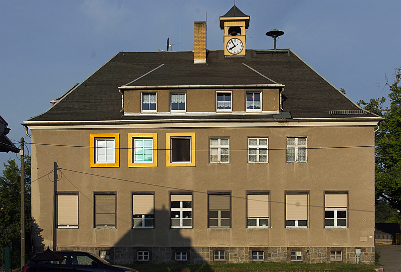 De in 1931 gebouwde school in Deutschbaselitz, waar Baselitz als Hans-Georg Kern geboren werd. De geel-omlijnde ramen markeren de woning van de familie Kern.