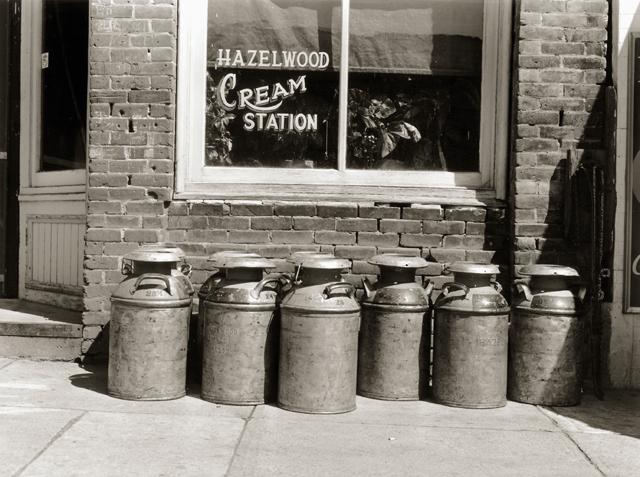 Cans of cream in front of the Hazelwood Cream Station in Genesee, Idaho, 1941