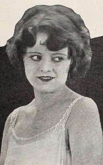A young white woman with bobbed dark hair, wearing a 1920s slip dress with sequined straps.
