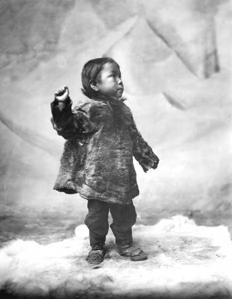 File:Eskimo child standing on fur rug in the studio, Nome, Alaska, between 1903 and 1906 (AL+CA 6359).jpg