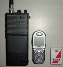 File:ICOM IC-2E and generetions of mobile phones.jpg