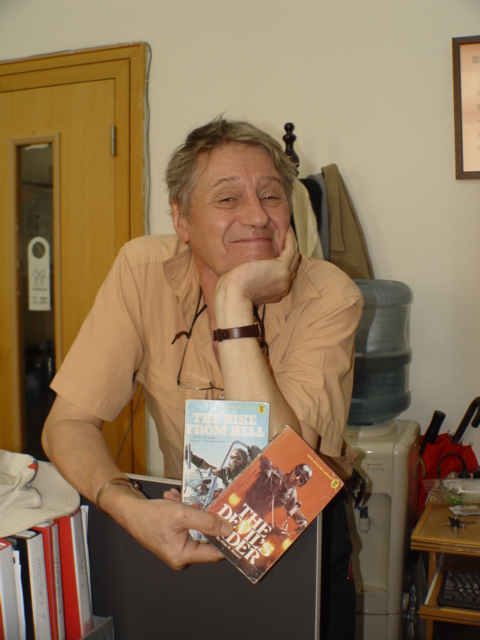 Richard Gordon in 2007 in Shanghai, China holding two of his earliest works, The Bike from Hell and The Devil’s Rider