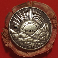 Badge of French Workers Party (Parti Ouvrier Francais) with rising sun on a red rosette background, 1893 Badge of the French Workers Party (Parti Ouvrier Francais) 1893-1905.jpg