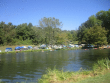 More tents bordering the Riverbend Farm lake