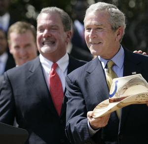 Irsay smiling next to Bush, holding a Stetson hat with a Colts logo on it