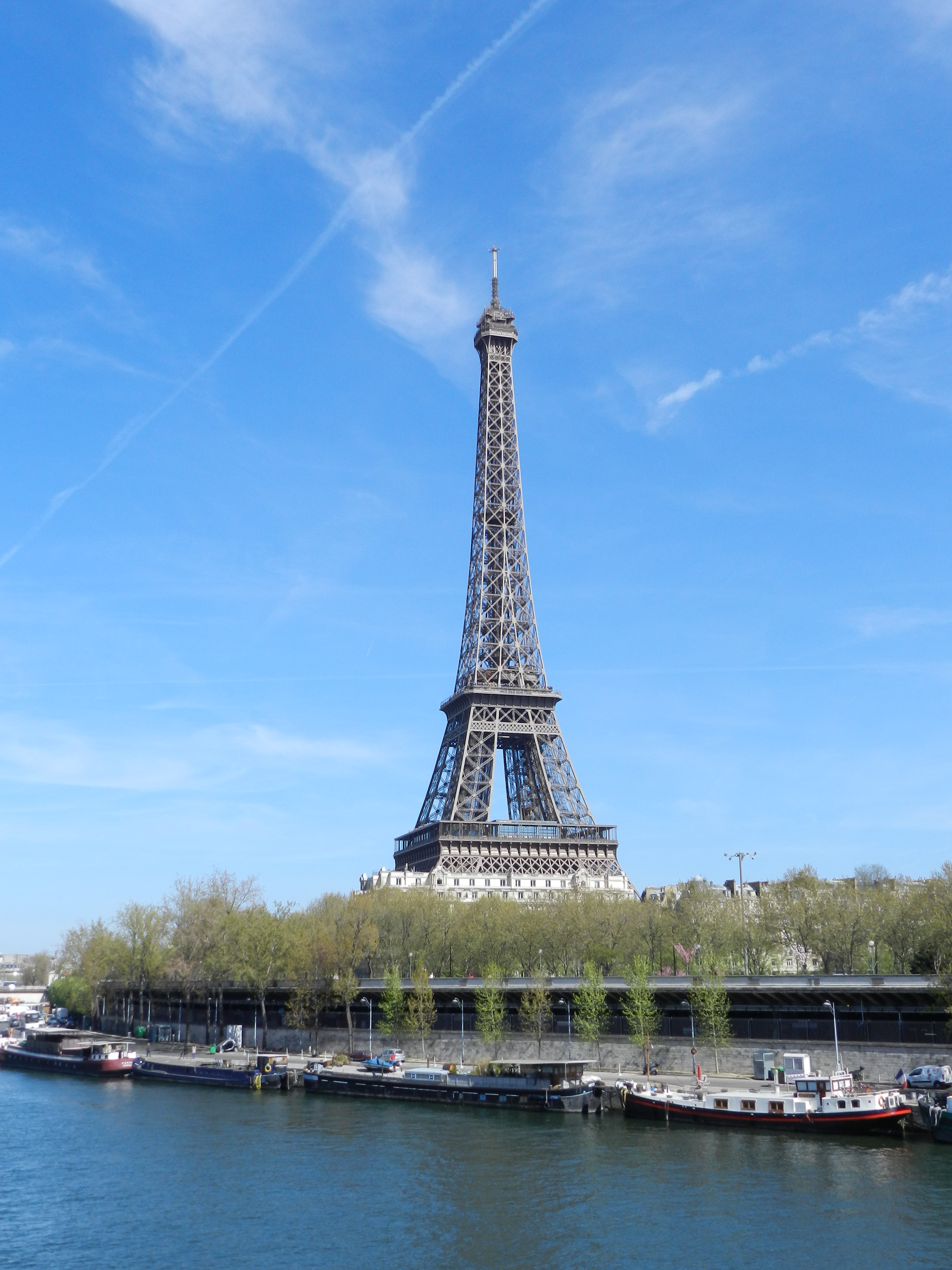 April towers. The Eiffel Tower is located on the Banks of the seine River in Paris..